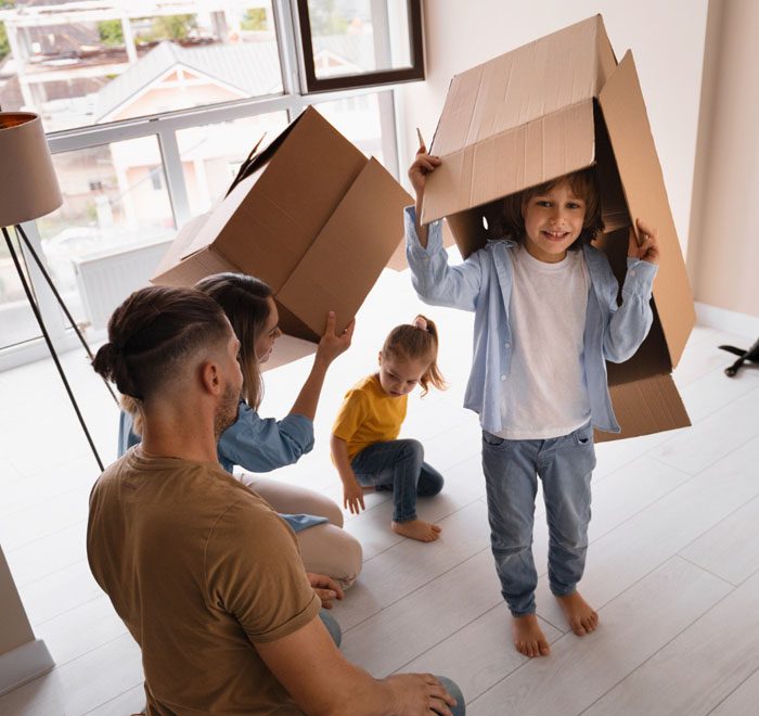 Family with cardboard box