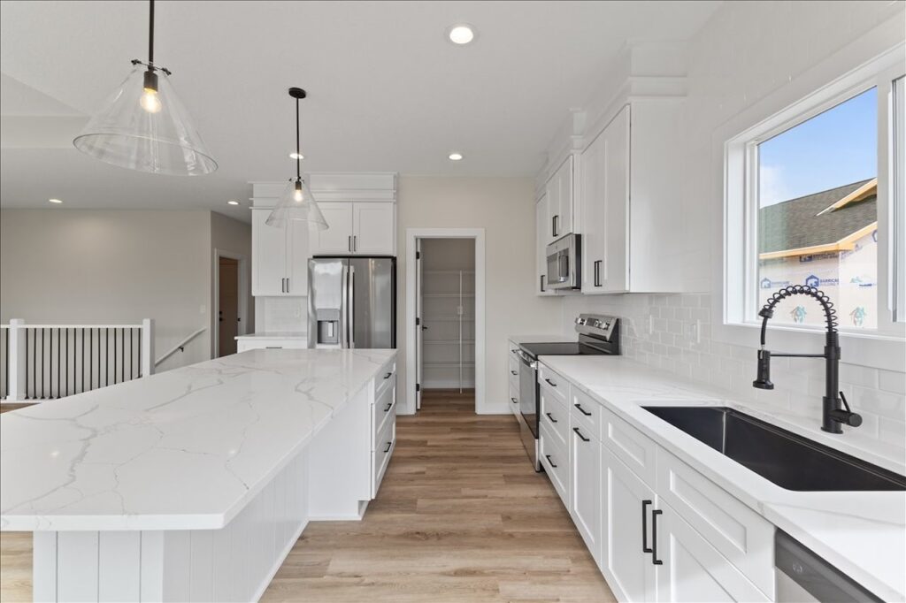 This is an image of our new available home's address - 575 NW Prairie Rose Ln in Waukee, IA Kitchen sink and cabinet view