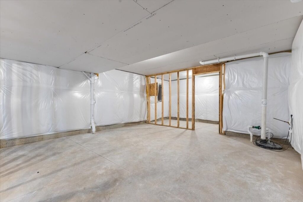 Unfinished room featuring construction tools and a wall, showcasing new Gladiator Homes for sale at 304 S Valley View Dr, Norwalk, IA.