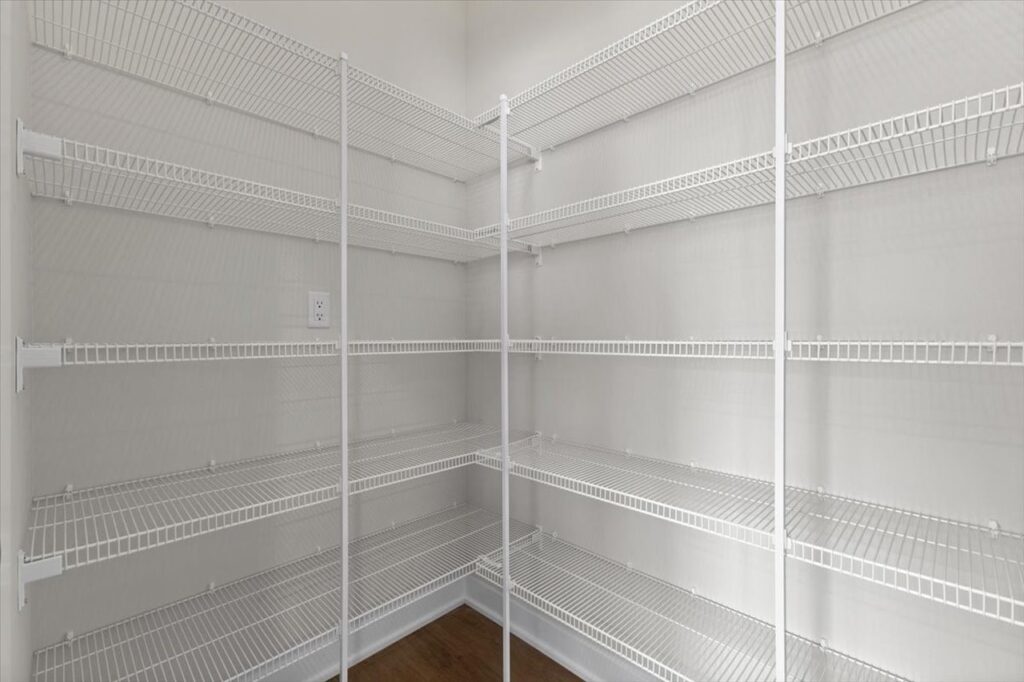 White pantry with shelves and a door, featured in new Gladiator homes for sale at 304 S Valley View Dr, Norwalk, IA.