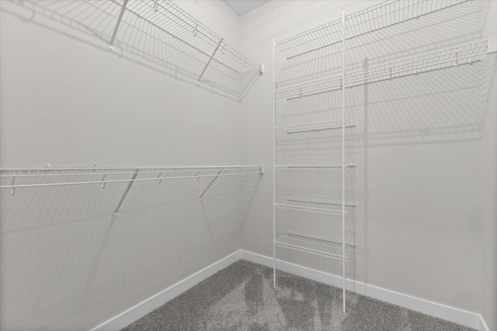 White pantry with shelves and a door, featured in new Gladiator homes for sale at 304 S Valley View Dr, Norwalk, IA.