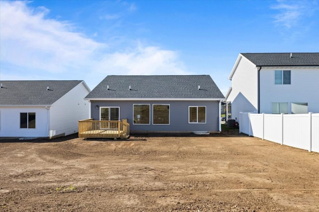A house with a fence and yard, showcasing New Gladiator Homes for sale at 304 S Valley View Dr, Norwalk, IA.