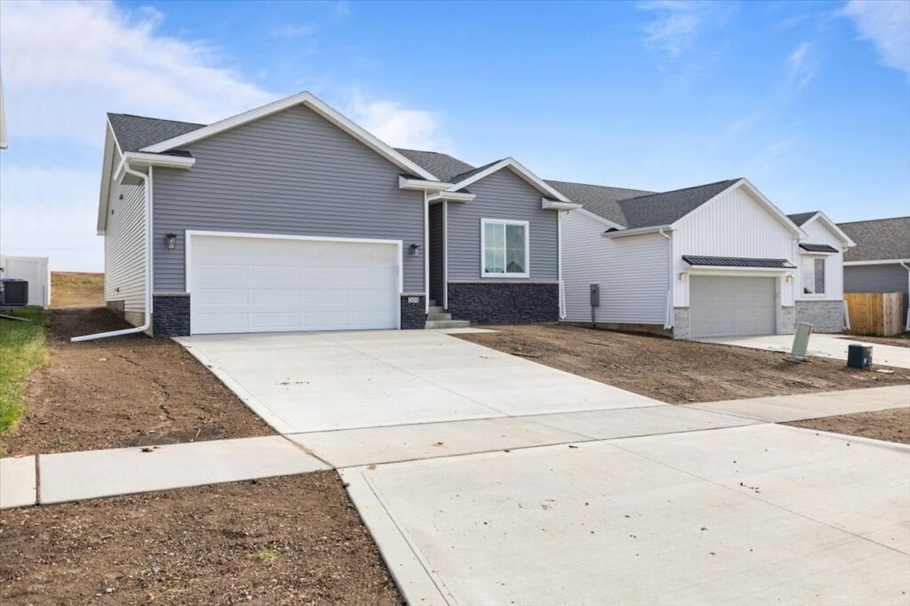 A new home with two garages and a driveway, located at 304 S Valley View Dr, Norwalk, IA.