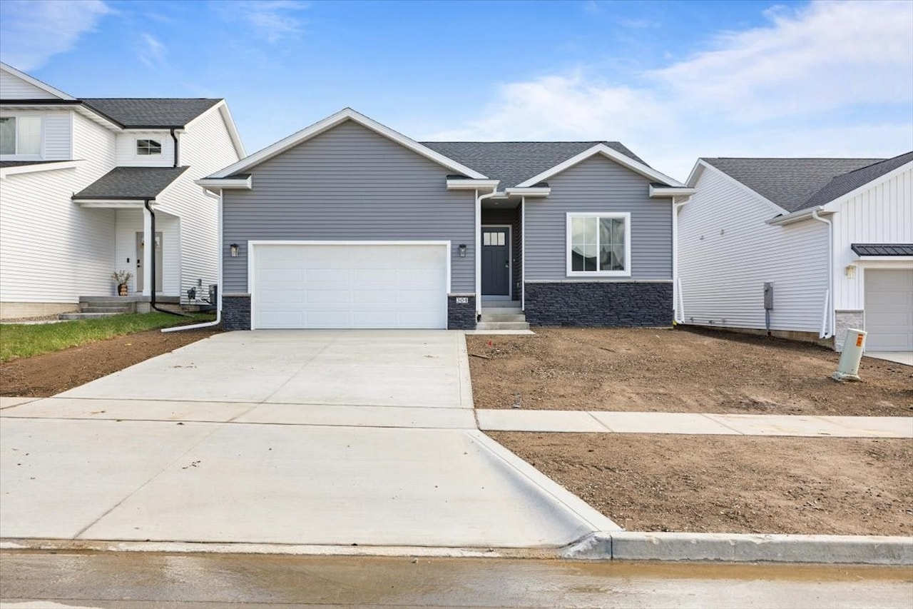 A new home with two garages and a driveway, located at 304 S Valley View Dr, Norwalk, IA.