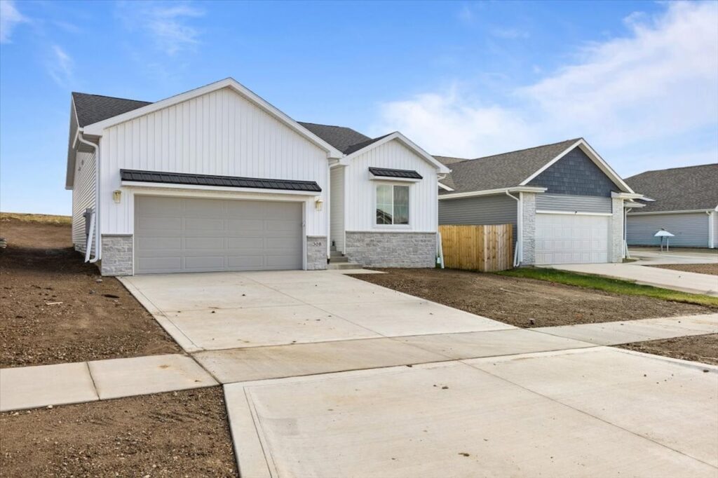A new home with two garages and a driveway, located at 308 S Valley View Dr, Norwalk, IA.