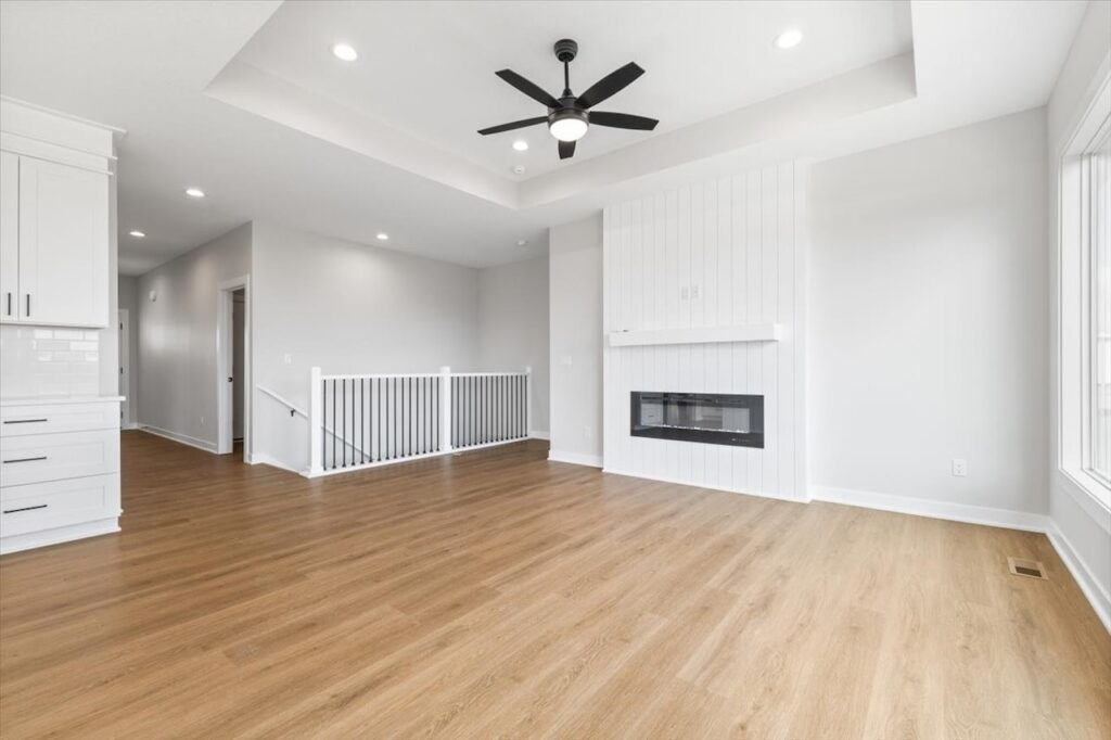 Empty room featuring a ceiling fan and a window, showcasing new Gladiator homes for sale in Norwalk, IA.
