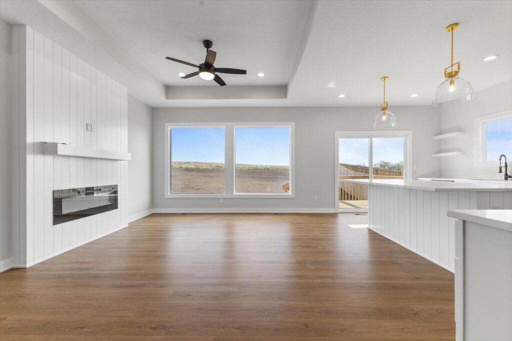 Empty room featuring a ceiling fan and a window, showcasing new Gladiator homes for sale in Norwalk, IA.