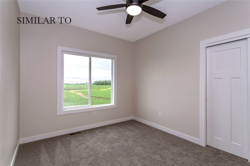 Interior hallway with a door and toilet, showcasing new Gladiator Homes available at 308 S Valley View Dr, Norwalk, IA.