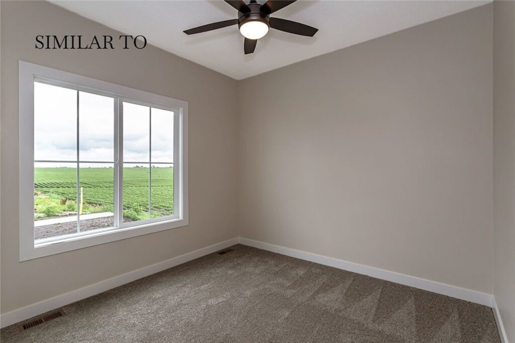 Room with a ceiling fan and window, part of Gladiator Homes' new listings at 308 S Valley View Dr, Norwalk, IA.