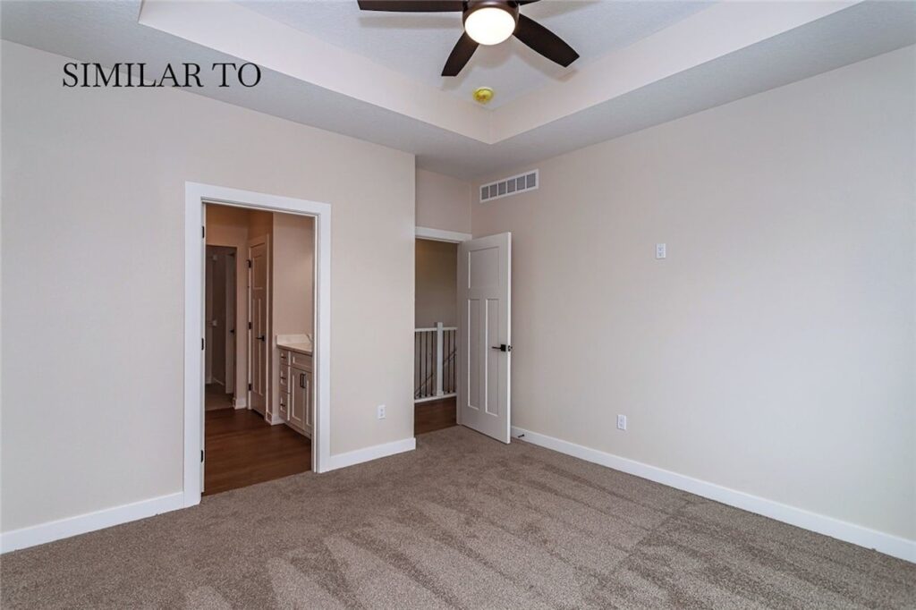 A cozy room featuring carpet and a ceiling fan, part of Gladiator Homes for sale at 308 S Valley View Dr, Norwalk, IA.