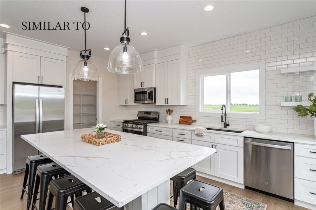 Modern kitchen featuring white cabinets and stainless steel appliances, part of new homes for sale at Gladiator Homes, Norwalk, IA.