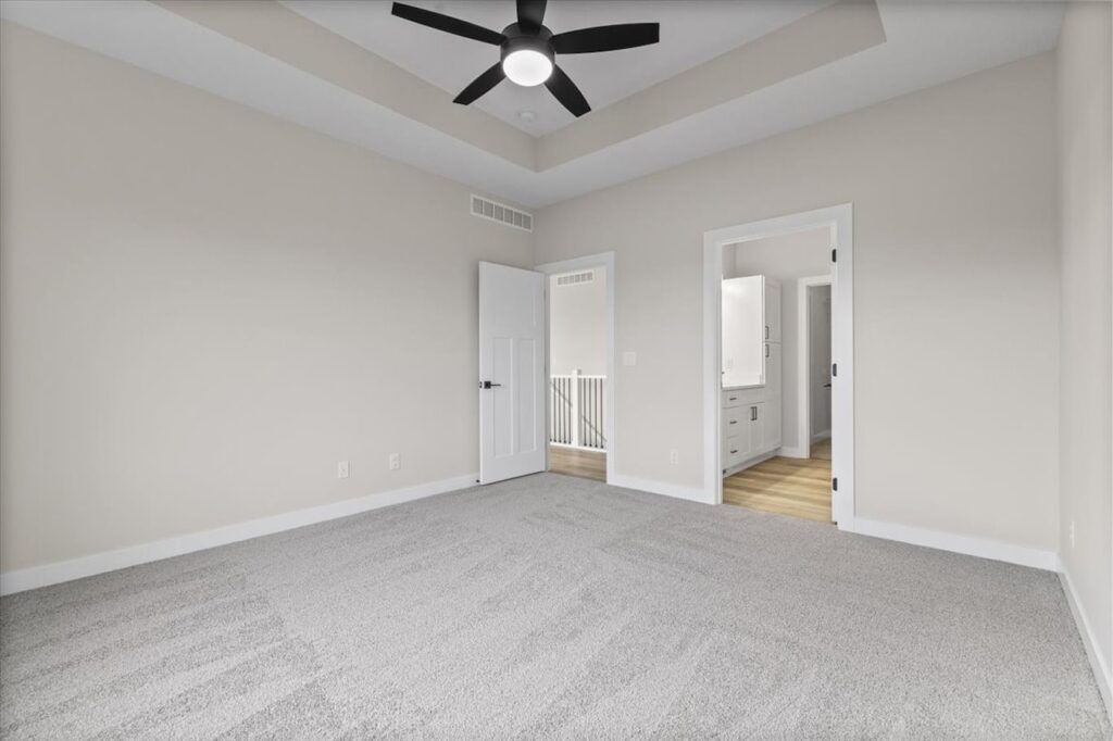 Empty room featuring a ceiling fan and window, part of the New Gladiator home for sale at 4517 NW 17th St, Ankeny, IA.