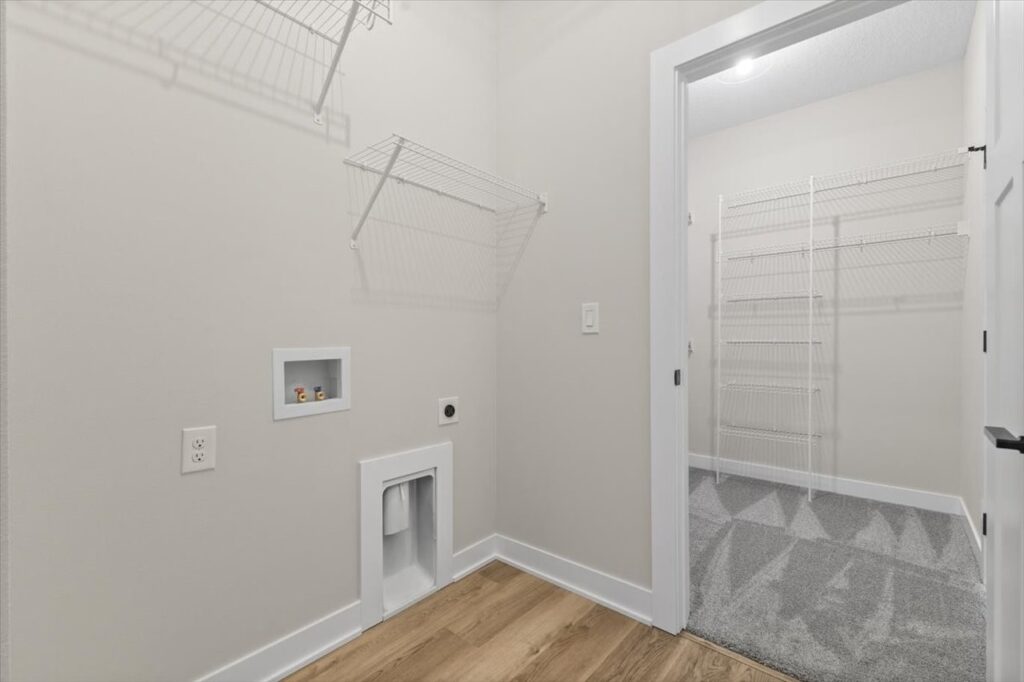Walk-in closet with organized shelves and a ladder, highlighting storage options in the Gladiator home at 4517 NW 17th St.