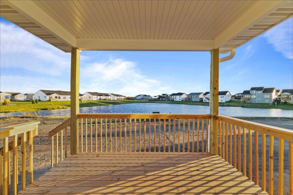 Scenic lake view from a porch, highlighting the tranquil setting of the New Gladiator home for sale at 4517 NW 17th St, Ankeny, IA.