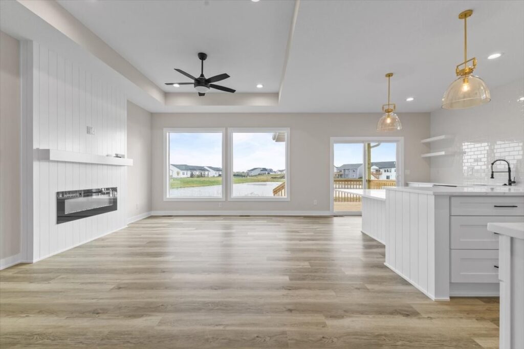 Kitchen featuring white cabinets and wood floors in the Gladiator home for sale at 4517 NW 17th St, Ankeny, IA.