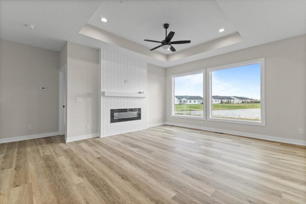 Bright kitchen with white cabinetry and wood flooring, located in the Gladiator home for sale at 4517 NW 17th St, Ankeny, IA.