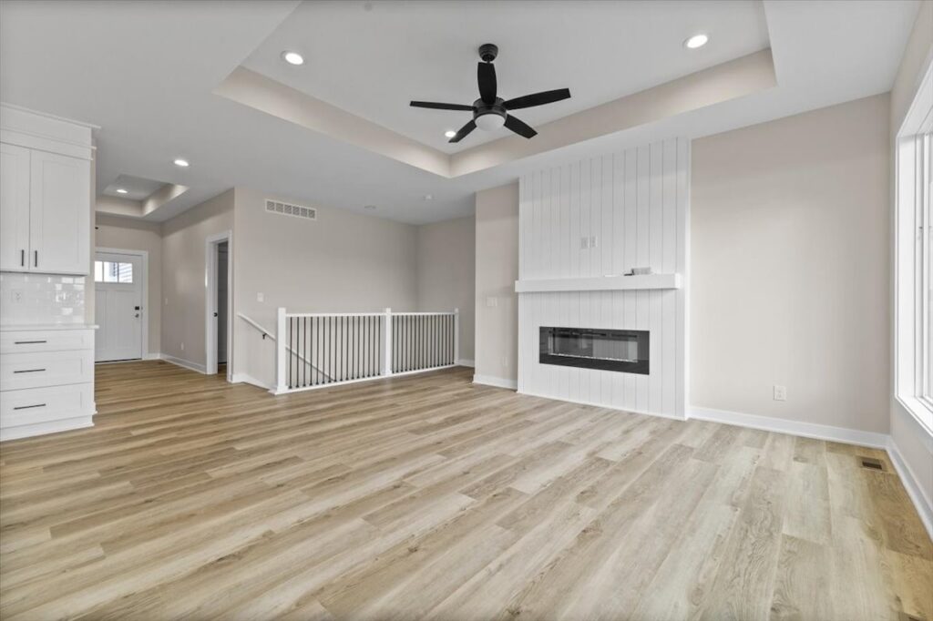 Elegant kitchen with white cabinets and a fireplace, showcased in the New Gladiator home for sale at 4517 NW 17th St, Ankeny, IA.