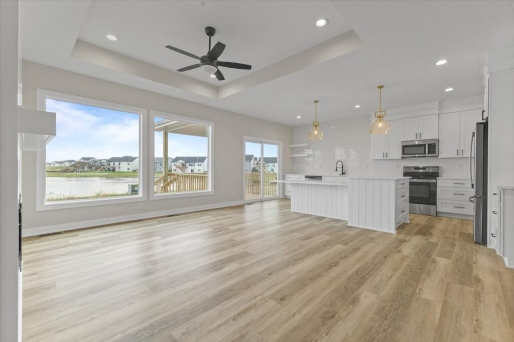 Modern kitchen with white cabinets and wood floors, part of the Gladiator home for sale at 4517 NW 17th St, Ankeny, IA.