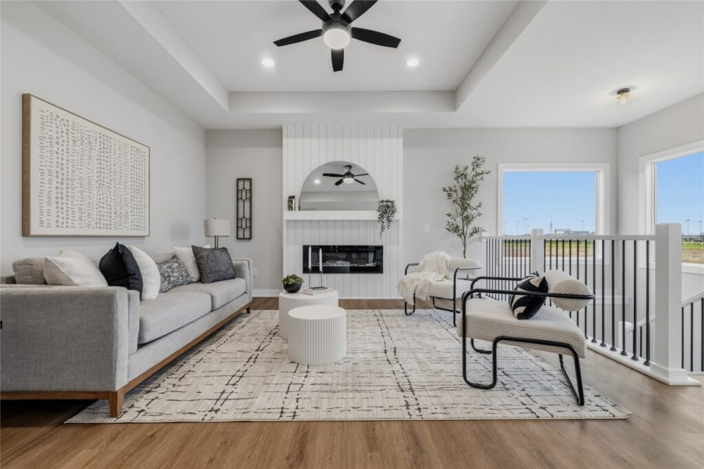 Living Room with Shiplap Fireplace and Tray Ceiling – New Home in Waukee, IA | Gladiator Homes