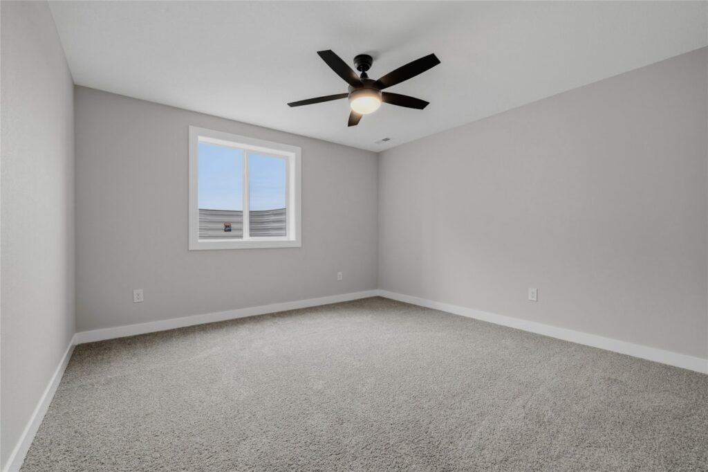 Third Bedroom with Ceiling Fan and Natural Light – Affordable New Home in Waukee, IA | Gladiator Homes