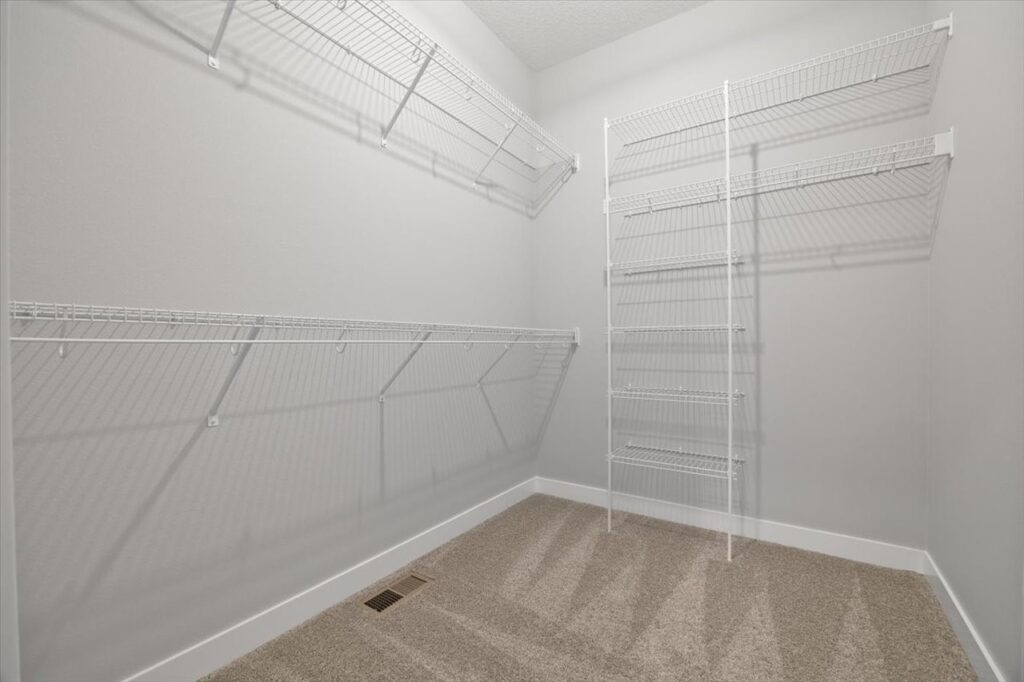 Interior of a pantry featuring shelves and a box, highlighting storage space in the home available at 321 11th St NW, Bondurant, IA.