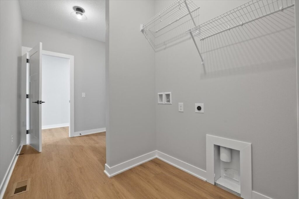 Interior of a pantry featuring shelves and a box, highlighting storage space in the home available at 321 11th St NW, Bondurant, IA.