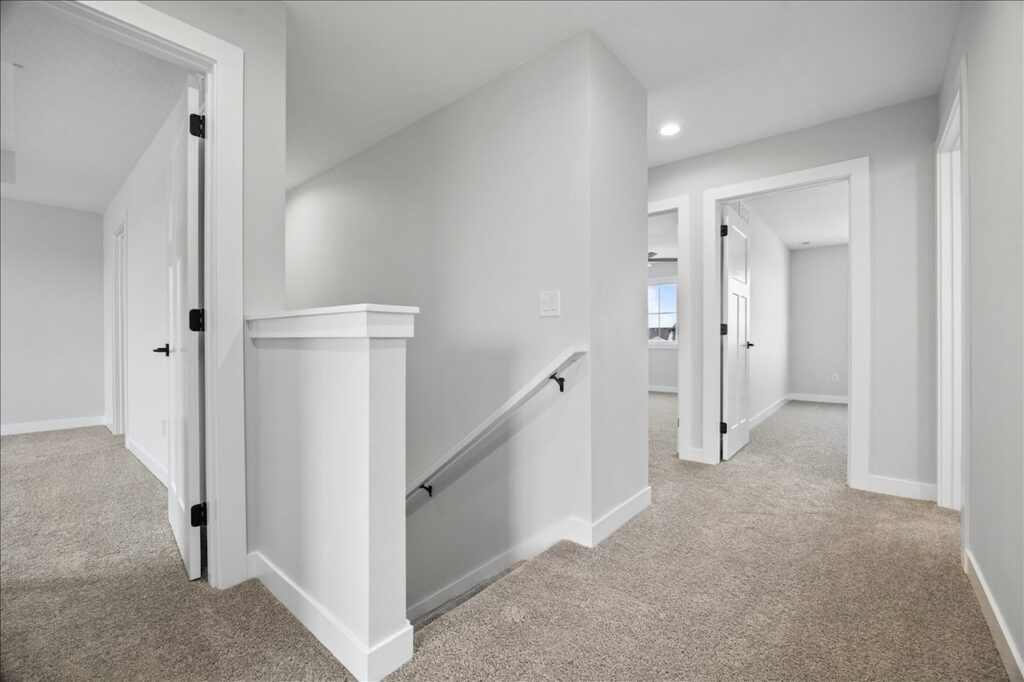 Interior hallway with a door and a white door, showcasing the available home at 675 NW Rosemont Dr, Waukee, IA